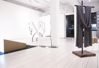 Install view of sculpture, textiles, and video work