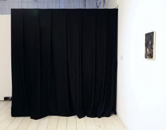 a space curtained off with a black curtain