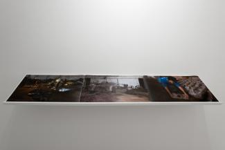 Installation views of  dark images on a white shelf