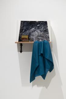 photograph, small treasures, a piece of blue fabric, installed on a small shelf