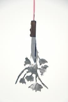 metal knife and bouquet of metal flowers hanging