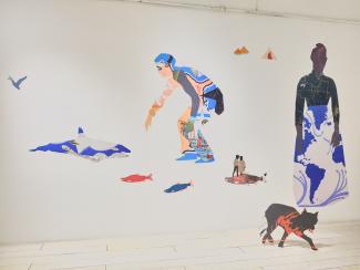 Installation of collaged work on the wall and extending into the space as 2D sculptures, featuring human and animal figures.