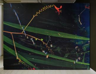 A dark, abstract image featuring intertwined green leaves on a black background with scattered colourful, iridescent specks, insects, and a single red flower.